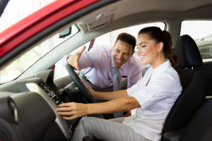 Woman-in-drivers-seat-man-handing-her-keys-ram-dealer-dick-huvaeres-richmond-chrysler-dodge-jeep-ram-richmond-mi